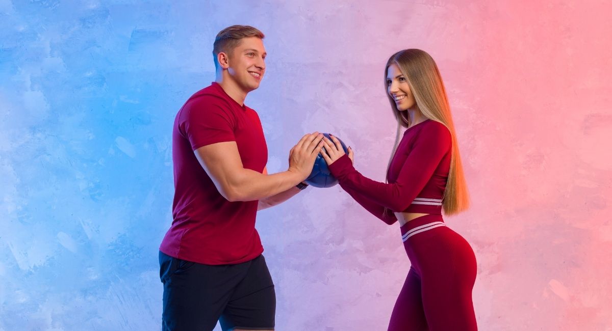 fitness couple holding a ball together